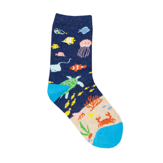 A pair of colorful children's socks with under the sea animal patterns including fish and crabs on a blue background.