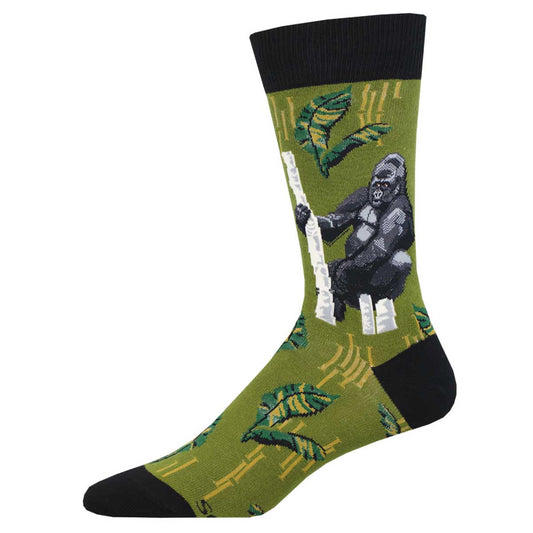 A pair of green crew socks with a black and white gorilla design and leaves around the ankle area.