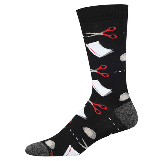 A black sock with a unique design featuring red scissors and white paper elements.