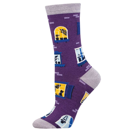 A pair of purple crew socks with a pattern of windows and cats looking out from the windows.