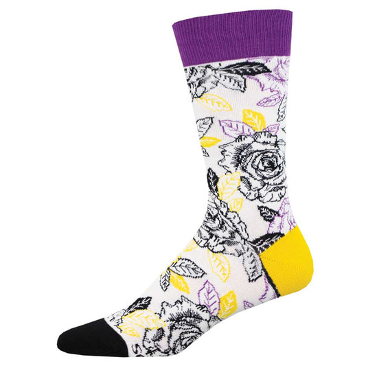 A pair of colorful socks featuring a pattern of roses and other plant motifs, with purple at the cuff and a yellow heel and toe.