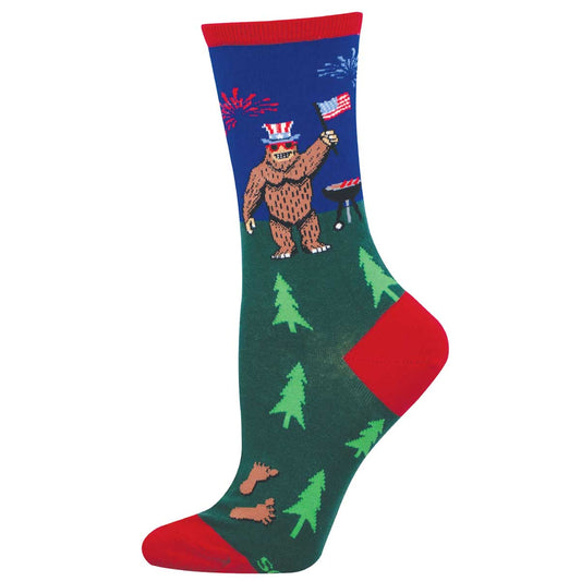 Sock with bigfoot wearing an American flag hat and grilling with trees on a blue and red background