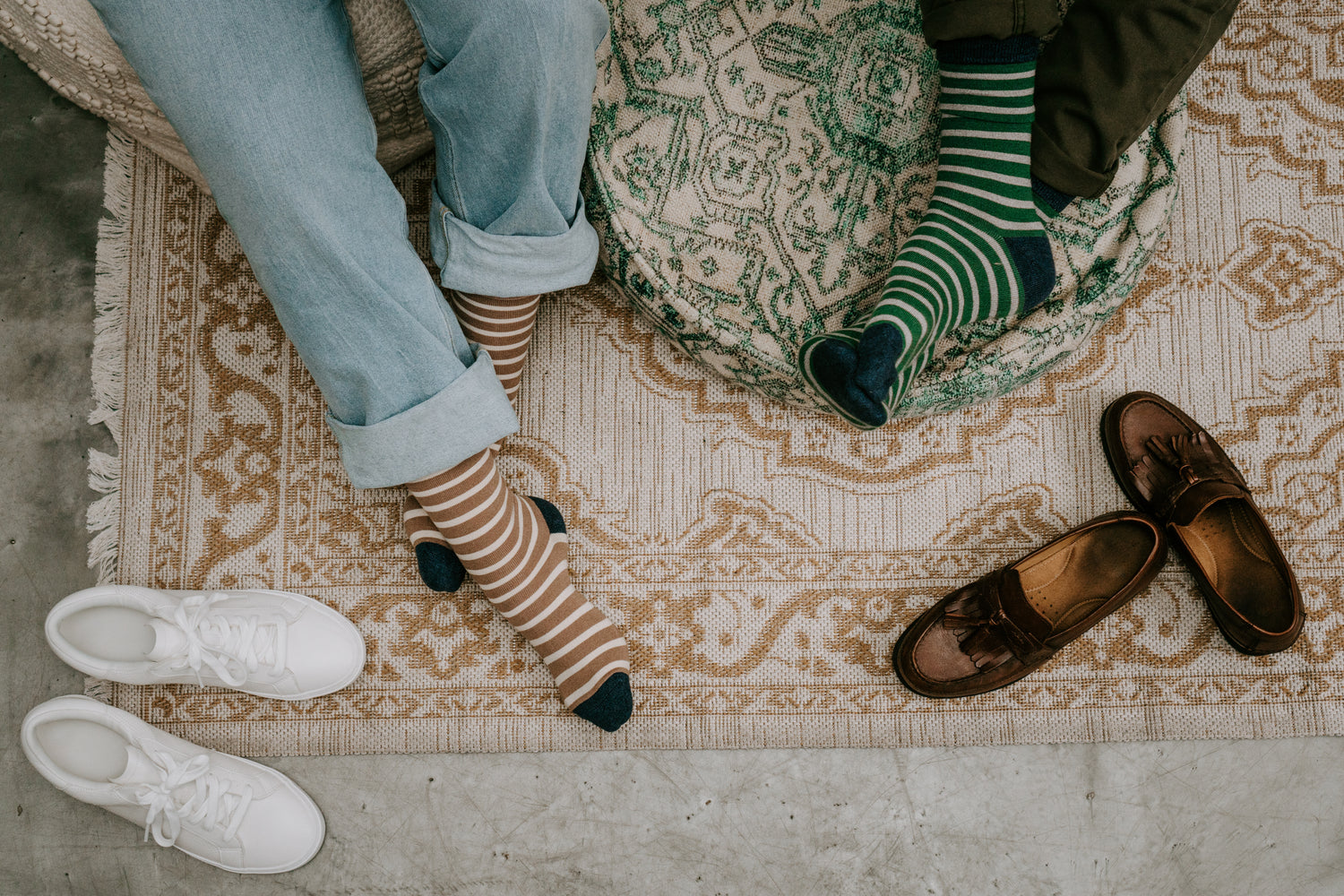 two pairs of feet wearing striped bamboo socks
