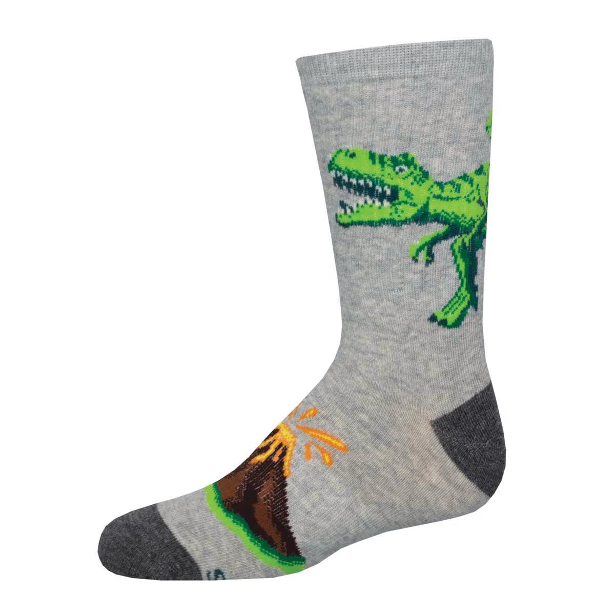 A pair of gray athletic youth crew socks with a vibrant dinosaur design, featuring a green T-Rex and orange volcano motif on the side.