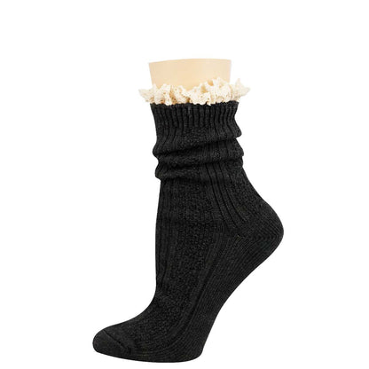 A single dark charcoal ribbed knit sock with a white ruffled trim at the top, displayed on a beige mannequin foot against a plain white background.