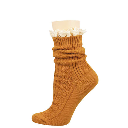 A single mustard yellow ribbed knit sock with a white ruffled trim at the top, displayed on a beige mannequin foot against a plain white background.