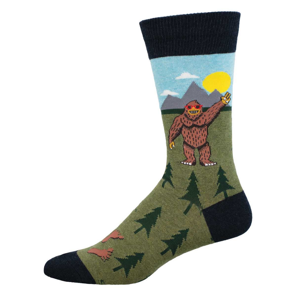 A pair of green crew socks with a pattern featuring a Bigfoot-like creature in a forest setting.