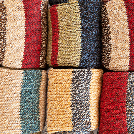 Close-up of textured sock fabric with multicolor stripes