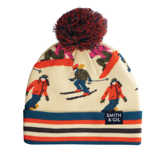 Colorful knit beanie with skiing design and pom-pom on a white background