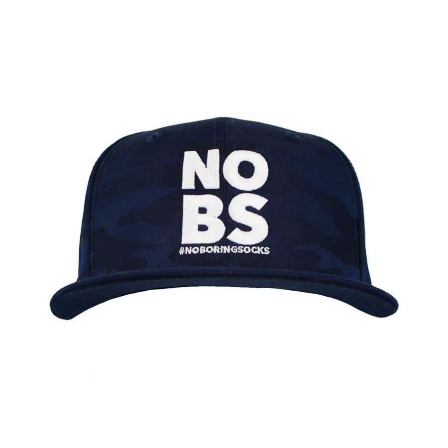 A navy camo flat bill hat with 'NO BS' #NoBoringSocks printed prominently in the center.