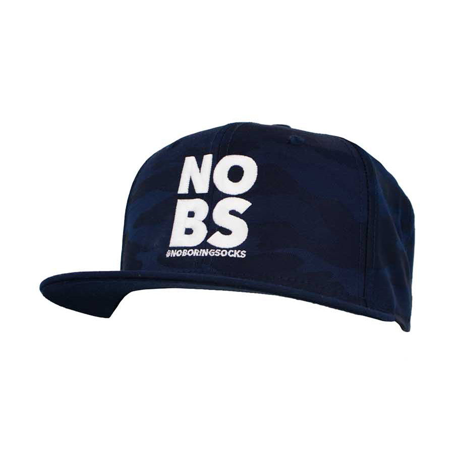 A navy camo flat bill hat with 'NO BS' #NoBoringSocks printed prominently in the center.