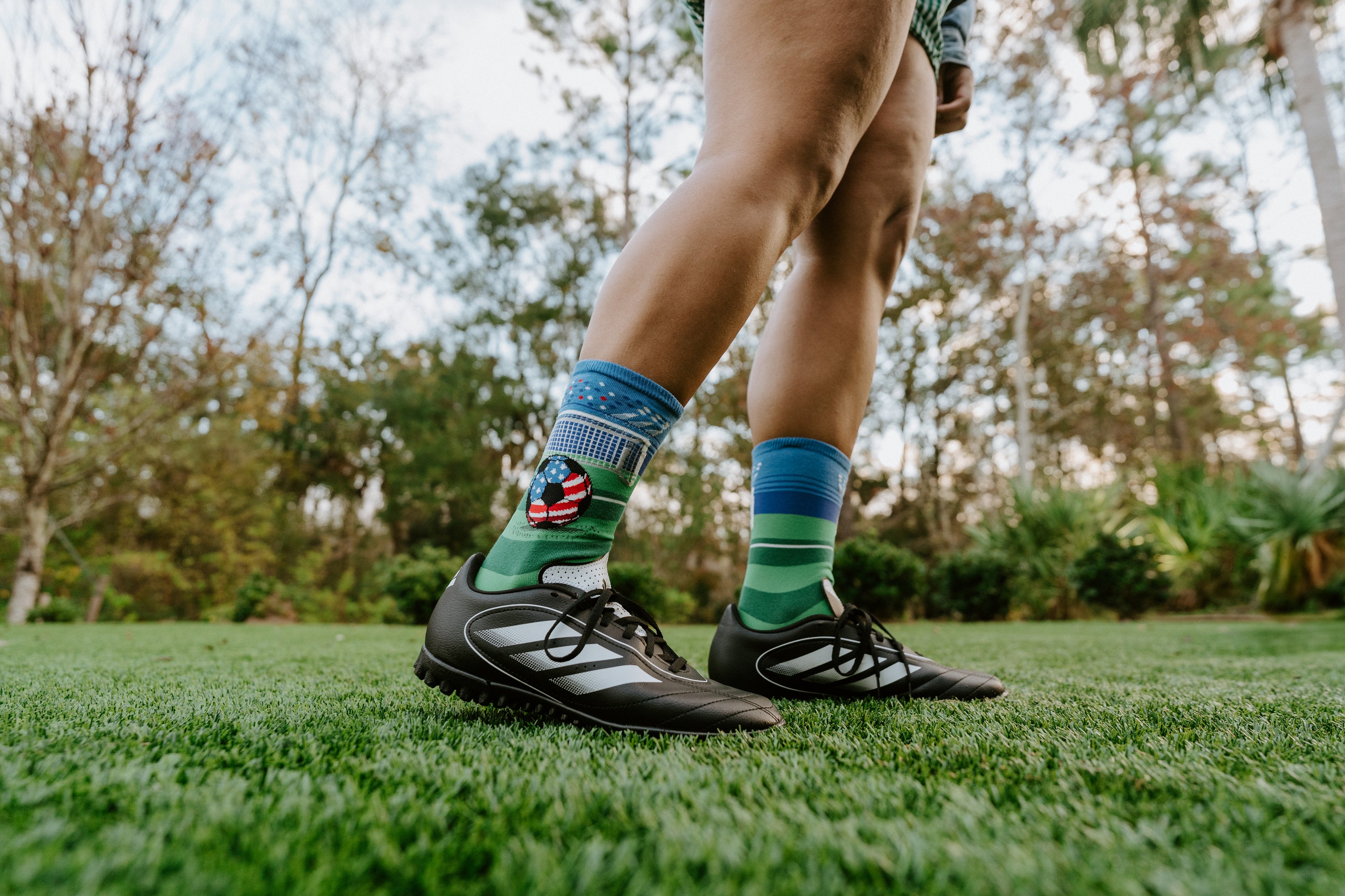 "soccer player on grass field wearing soccer socks"