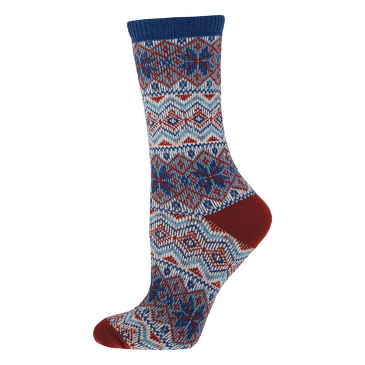 A pair of sweater socks with a geometric snowflake pattern in red, blue, and white colors.