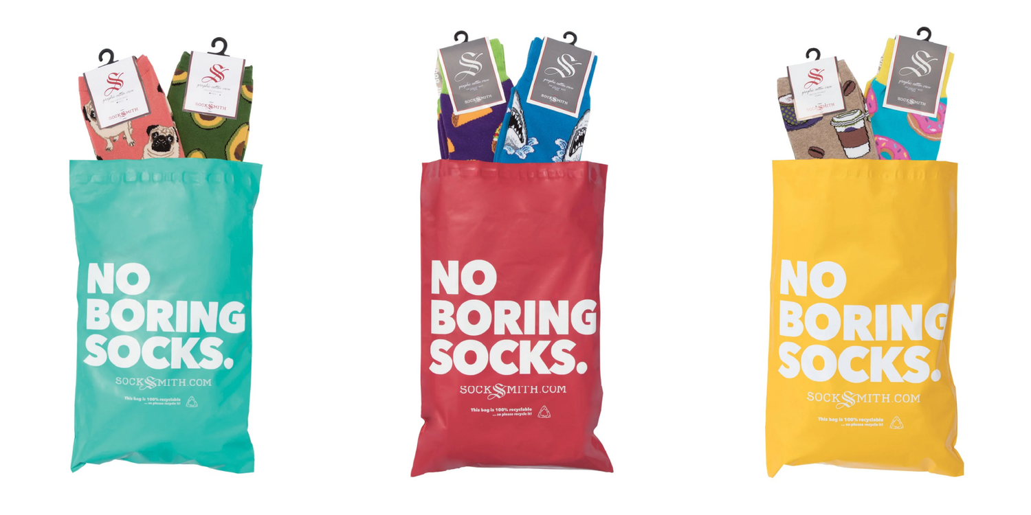 Three colorful bags labeled 'No Boring Socks' with pairs of socks inside.