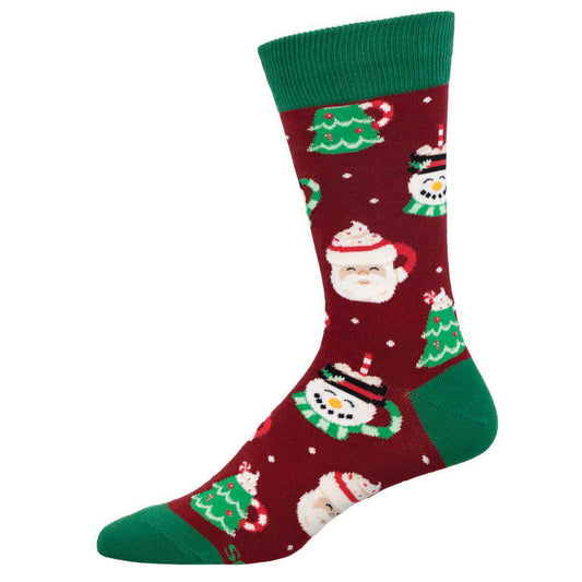 A pair of Christmas-themed cotton crew socks featuring patterns of Santa Claus, Christmas trees, and presents on a red background with green cuffs.
