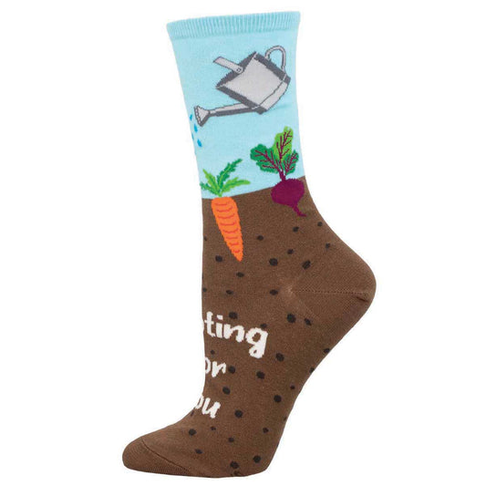 A pair of colorful crew socks with a gardening theme, featuring vegetables, soil, and a watering can featuring the text 'Rooting For You'.