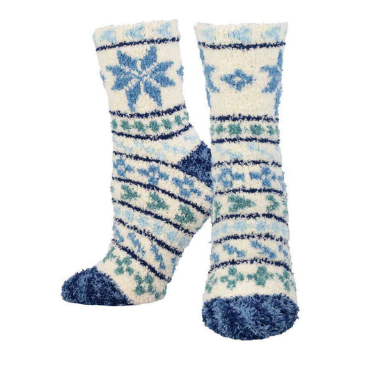 A pair of fuzzy socks with a fair isle pattern in white, blue, and green.
