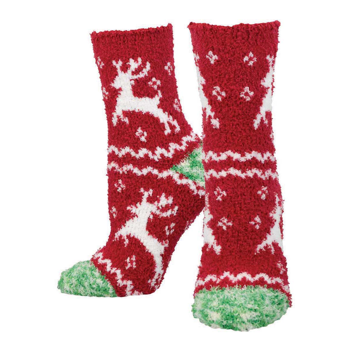 A pair of fuzzy red holiday socks with white reindeer and green accents.