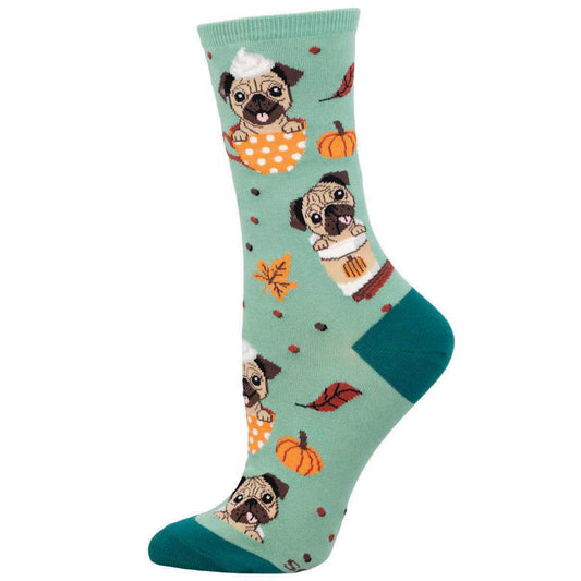 A pair of green socks with a pattern of pug dogs, pumpkins, and autumn leaves.