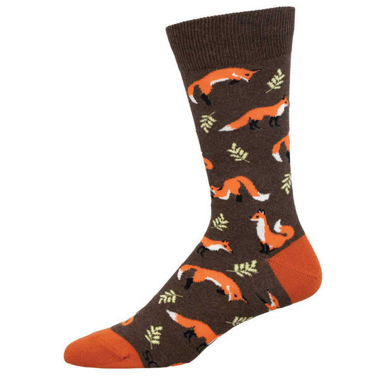 A pair of brown crew socks with a pattern of orange foxes and green foliage.