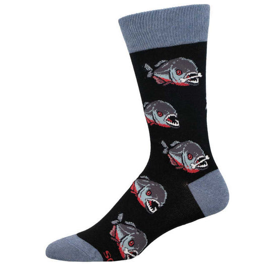A pair of black crew socks with a pattern of red piranhas, displayed against a white background.