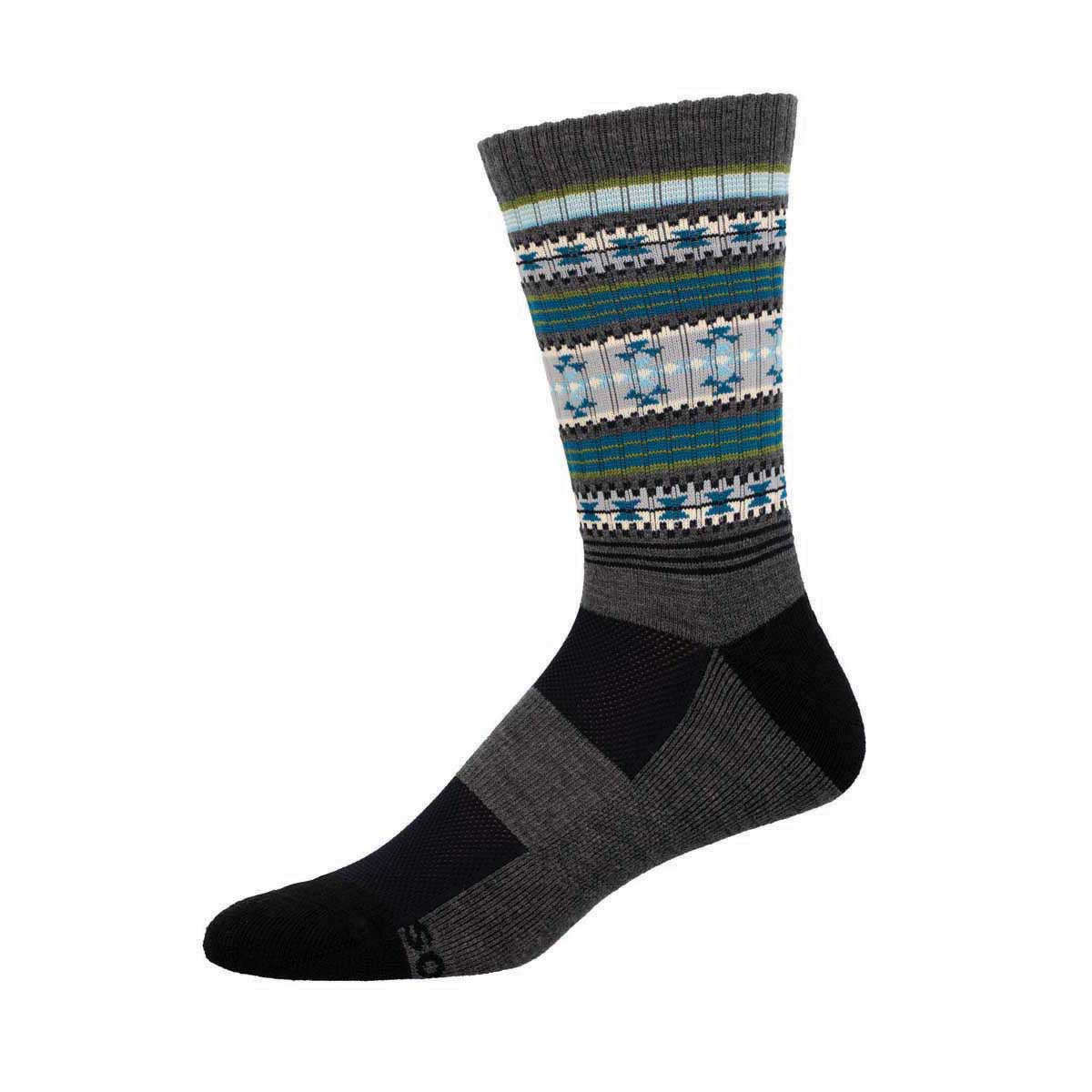 A pair of crew-length Merino wool socks with a striped pattern in various colors including green, blue, and beige on a charcoal background.