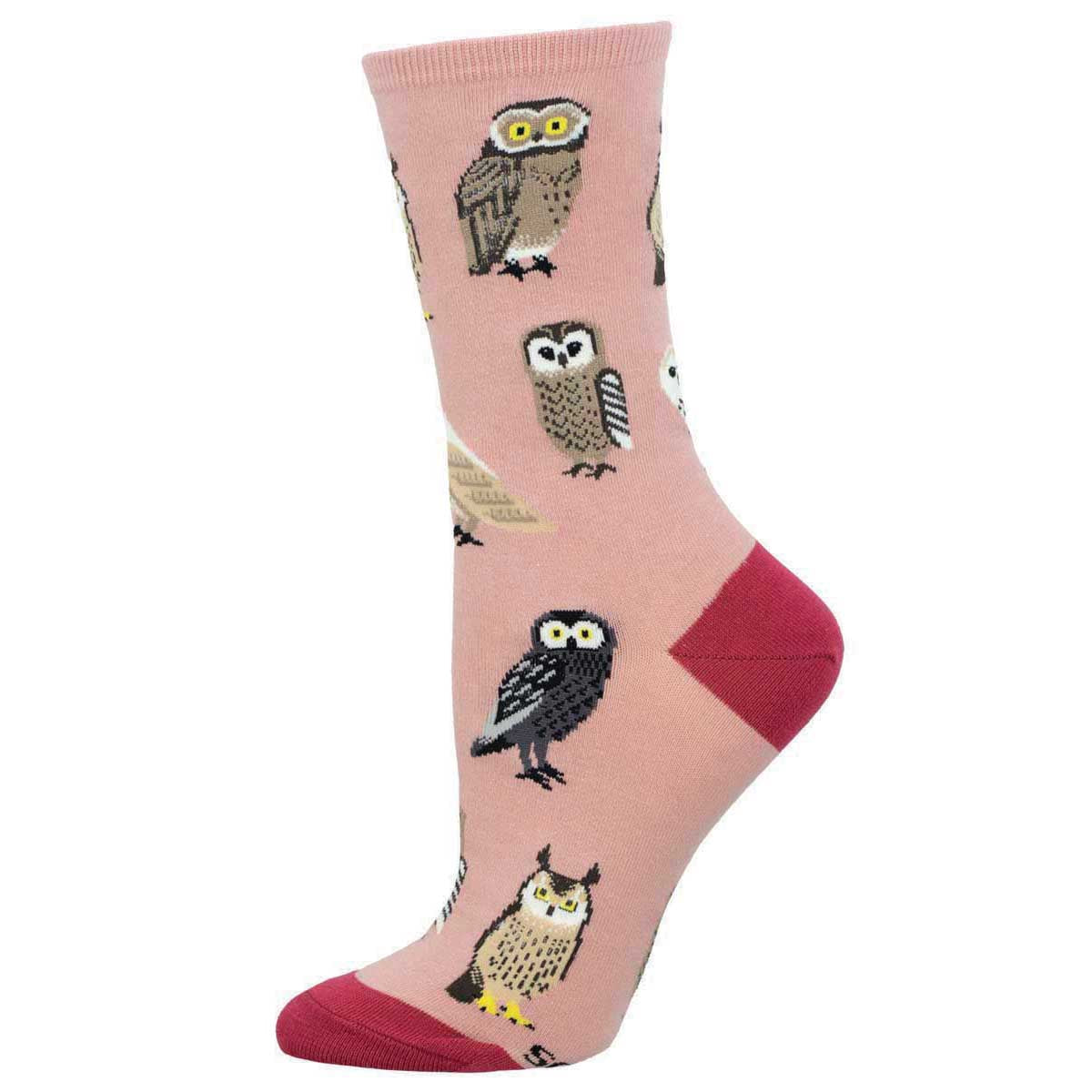 A pair of pink crew socks with various owl designs and darker pink heel and toe caps.