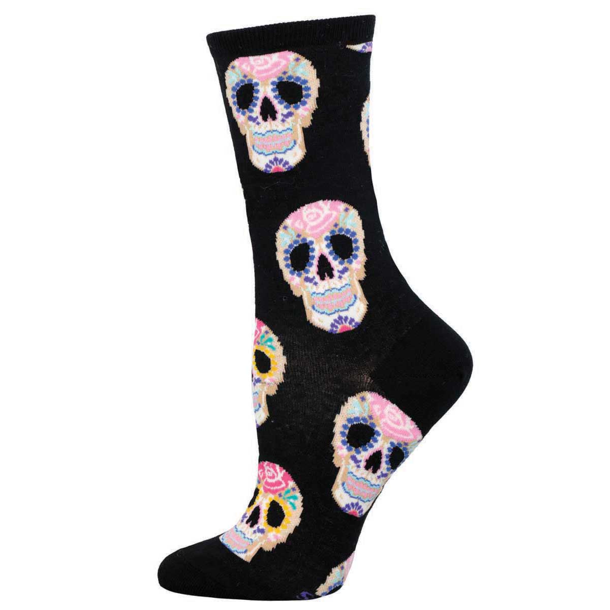 A pair of women's crew socks featuring a pattern of colorful white Dia De Los Muertos sugar skull on a black background.